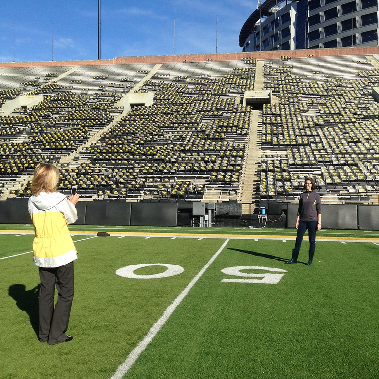 Colleagues from the UI College of Pharmacy paused for a photo on the Kinnick Stadium 50-yard line during a group tour arranged by We Are Phil committee members in the college. Hawkeye Football is one of many programs on campus that receives charitable con