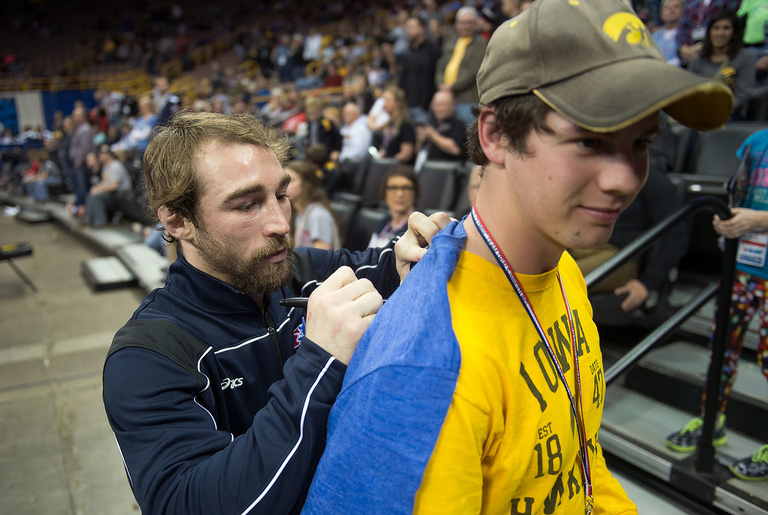 Daniel Dennis signs an autograph for a lucky fan prior to the introduction of the 2016 US Olympic Wrestling team.