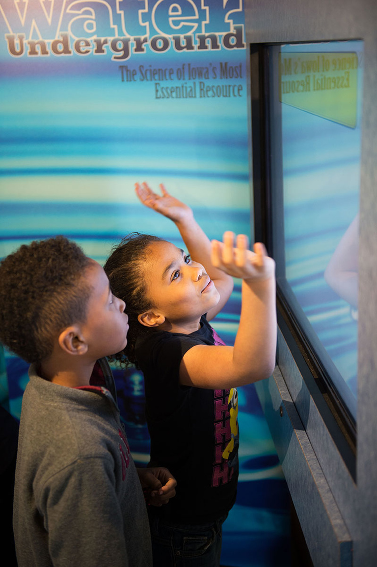 A Lucas student plays with one of the interactive screens in the Mobile Museum.
