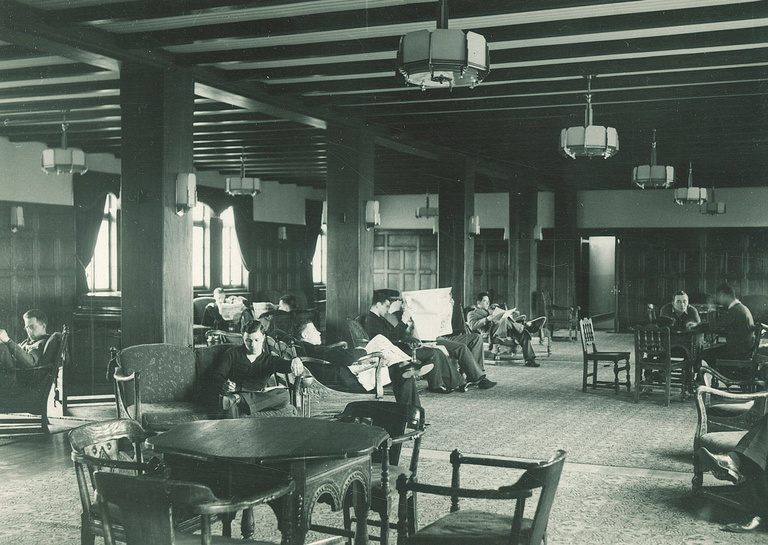 Black-and-white image of men seated in Quadrangle lounge.
