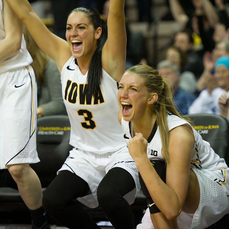 Claire Till and Kali Peschel celebrate on the bench