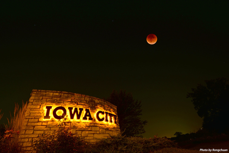 Blood moon over the Iowa City sign