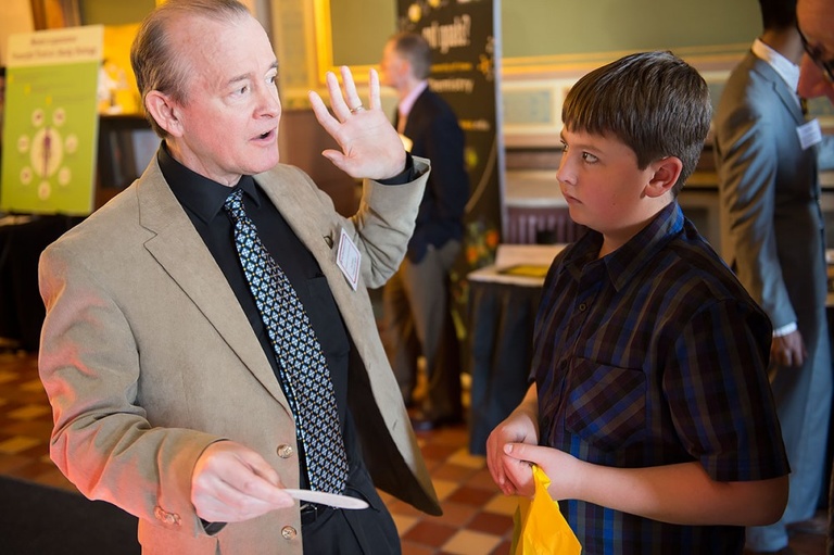 Frederick Skiff, from Physics and Astronomy, explains the VanAllen Radiation Belts to a student