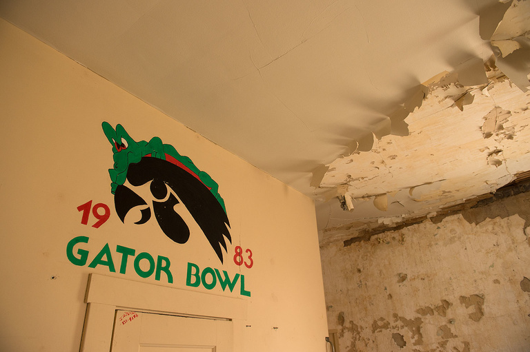 Color photo of deteriorating ceiling and artwork in a long-unoccupied Quadrangle room