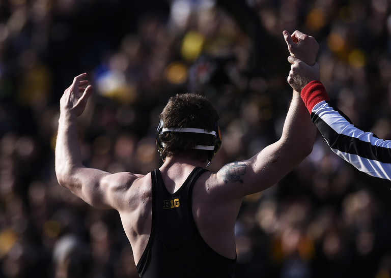 wrestler's arm raised in victory