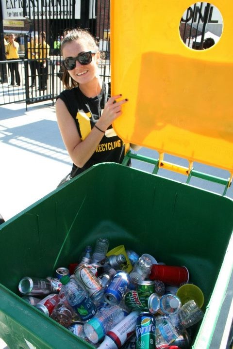 Rachel Price shows cans and bottles collected for recycling at Gate I outside Kinnick Stadium