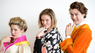 cast members and director of she stoops to conquer pose with finger to face