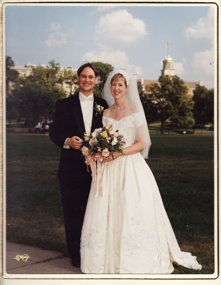 wedding photo of Jason and Alison Tibbetts standing with Old Capitol in the background