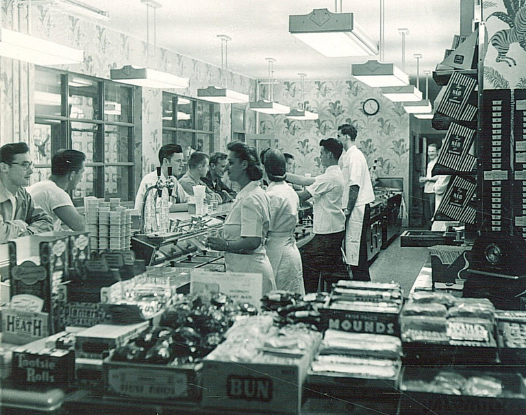 Employees serve students at the counter of the Quadrangle Grill in this 1949 photo.