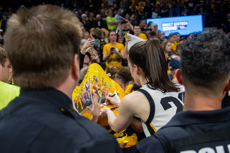 Caitlin Clark signs autographs after the game