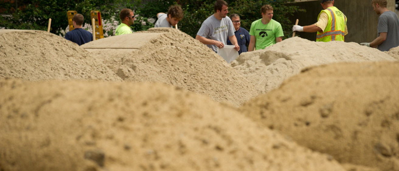 University of Iowa staff and students help fill sandbags that are being used around campus to protect against the Iowa River's rising waters. Photo by Tim Schoon