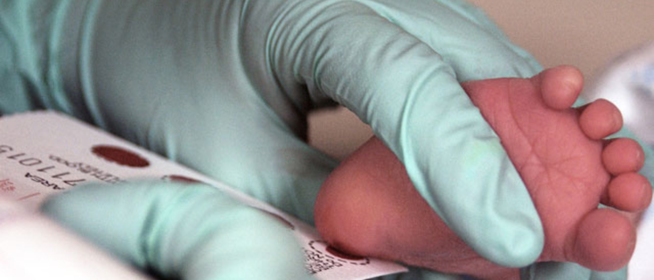blood sample being taken from an infant foot
