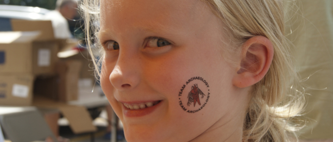 Georgie Oedekoven of Rock Rapids, Iowa, stopped by the Office of the State Archaeologist booth for a tattoo