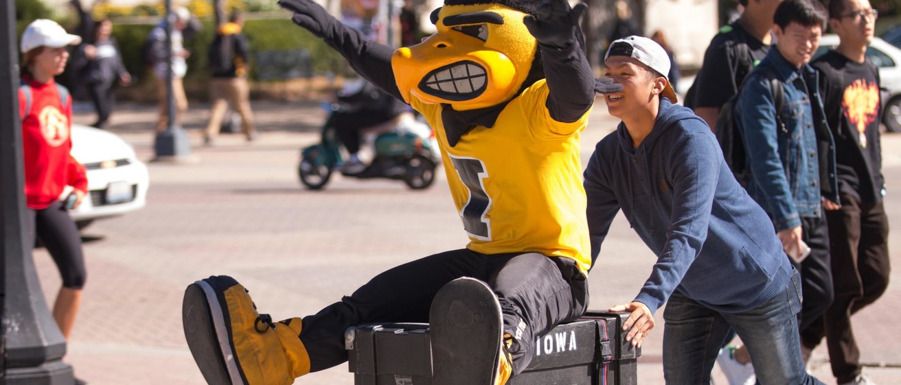 Herky "helps" the Pandelirium Steel Drum Band set up their instruments on the Pentacrest for the College of Liberal Arts & Sciences' We Are Phil celebration on Wednesday, September 30.