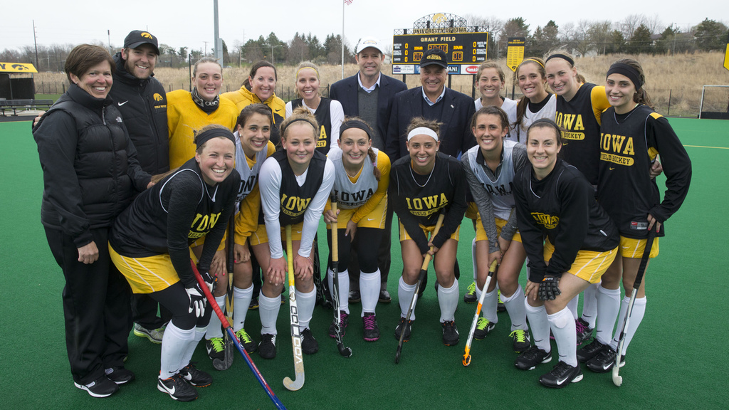 FIH President Leandro Negre presents an FIH pin to Natalie Cafone during their practice Wednesday, April 23, 2014 at Grant Field on the UI campus in Iowa City.
