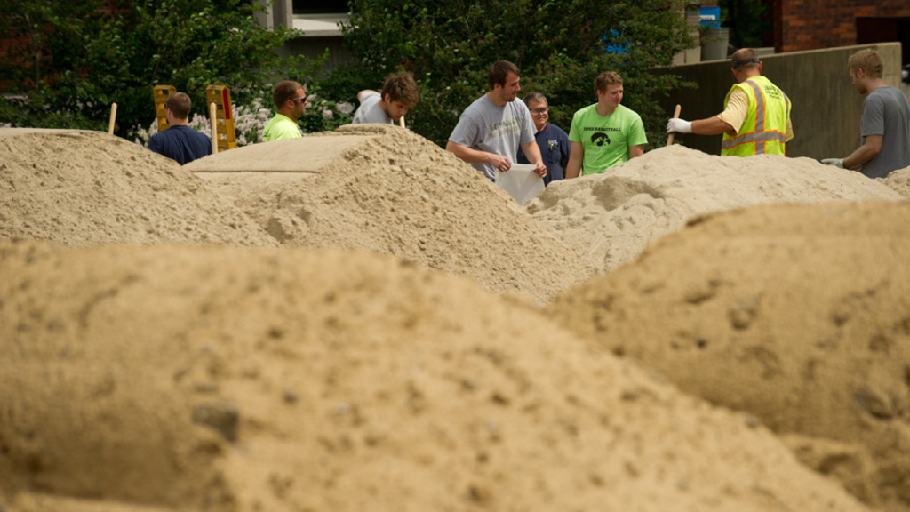 University of Iowa staff and students help fill sandbags that are being used around campus to protect against the Iowa River's rising waters. Photo by Tim Schoon