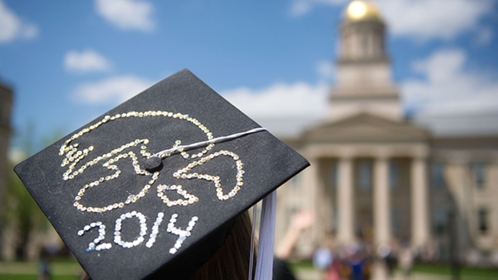A Tigerhawk-decorated mortar board looks up at the Old Capitol.