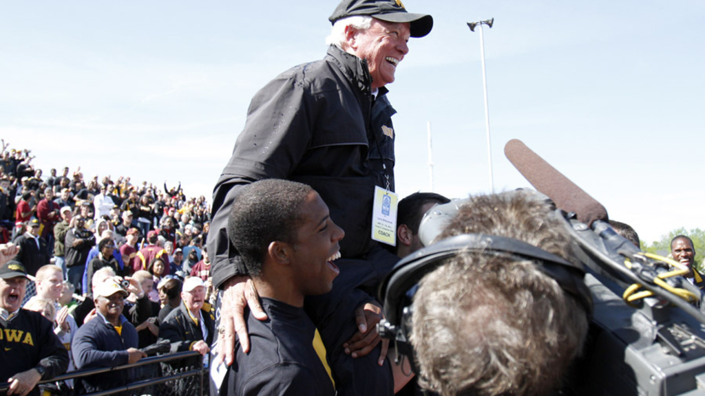 Larry Wieczorek being carried by athletes after winning the Big Ten championship
