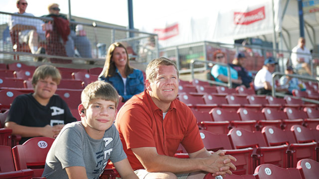 Jack Bickel with parents at a baseball game