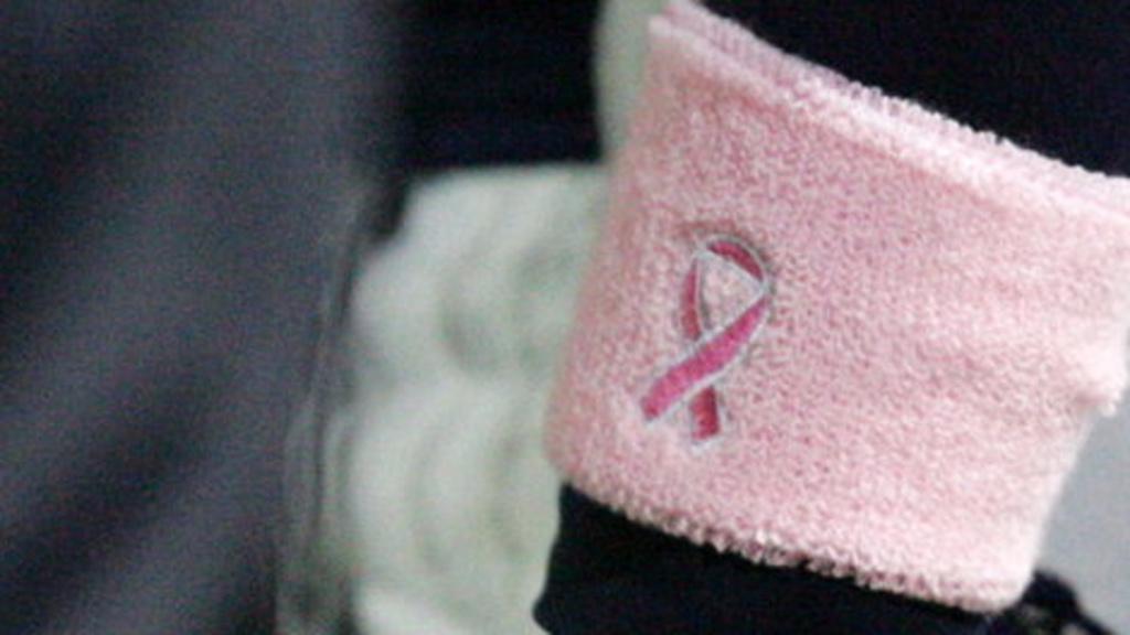 a close up of the breast cancer pink ribbon on an armband