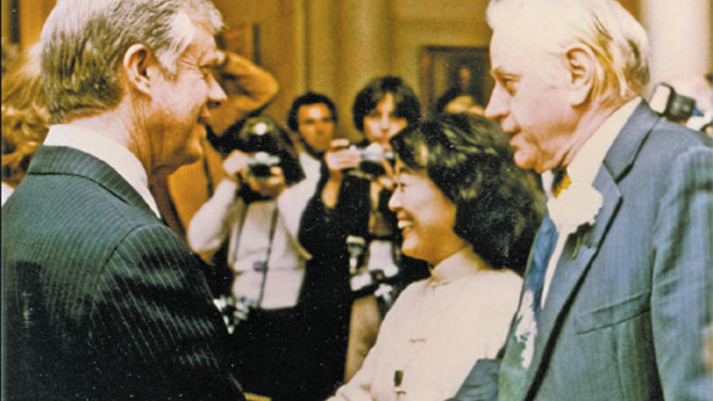 US President Jimmy Carter greets novelist Hualing Nieh and her husband, Paul Engle, a fellow writer, at a White House reception in 1982. Provided to China Daily 