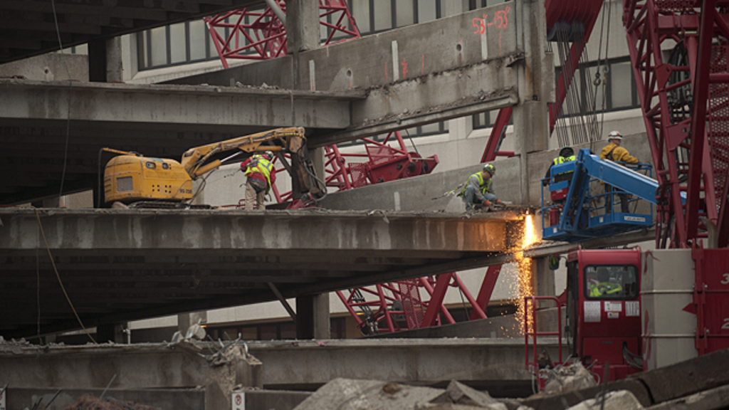 Workers dismantle a parking ramp