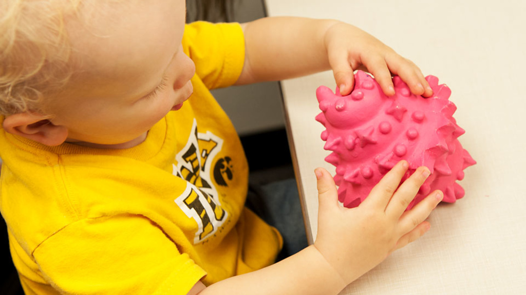 A toddler handles an object during a UI study on word learning