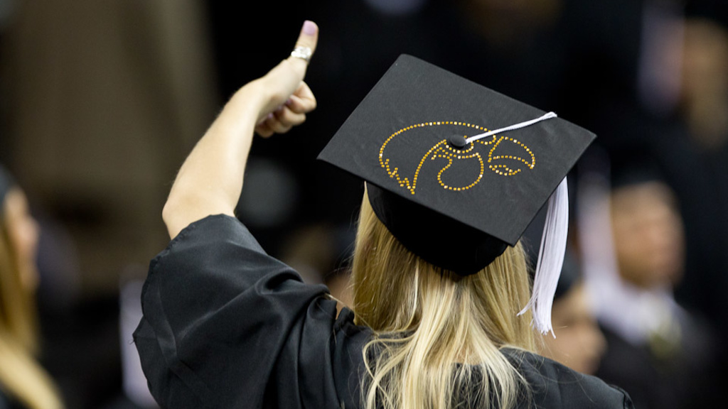 graduate gives a thumbs-up at commencement