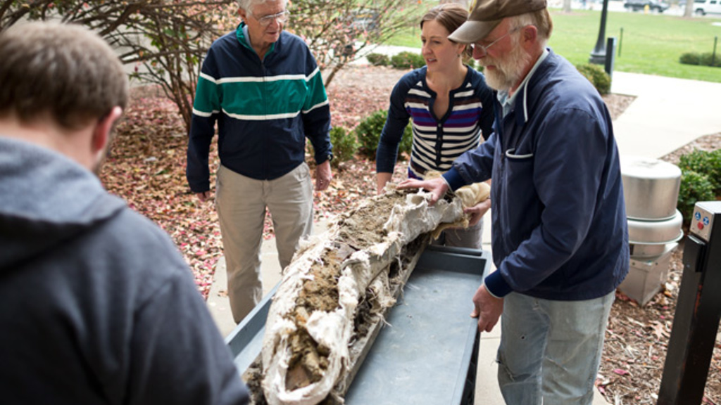 mammoth tusk being wheeled into the museum