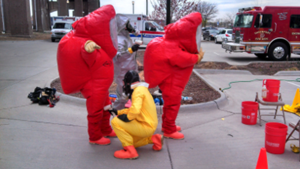 HazMat team members begin the decontamination process following a preparedness drill held on April 23 at Davenport’s Modern Woodmen Park. Members of the Hygienic Laboratory’s Emergency Preparedness team participated in the exercise to maintain readine