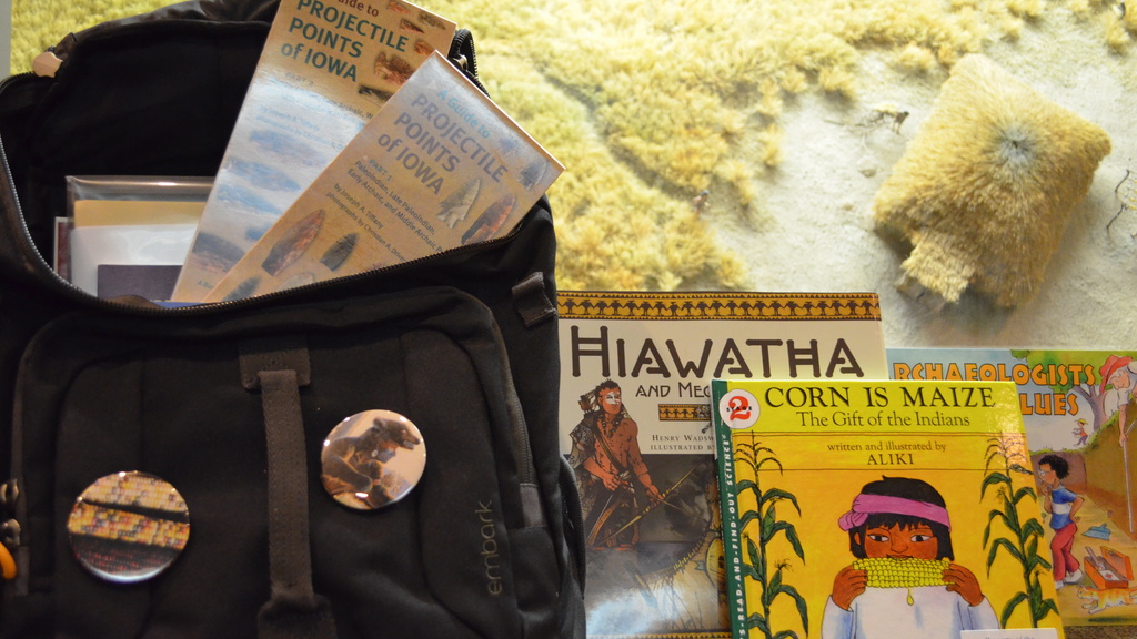 A bag with museum flyers in it and books for children