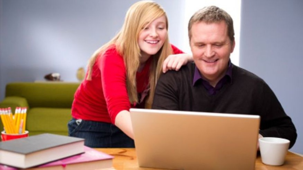 father and daughter at laptop