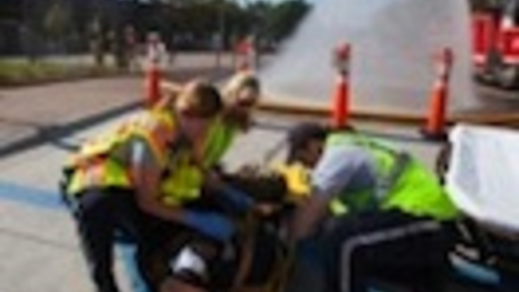 Emergency workers treat a mock patient