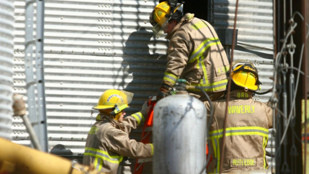 Waverly Fire Rescue respond to a call involving two men trapped in a grain bin at Scheider&#039;s Milling Inc. in Waverly, Iowa Thursday, Mar. 14, 2013. (TIFFANY RUSHING / Courier Staff Photographer) 