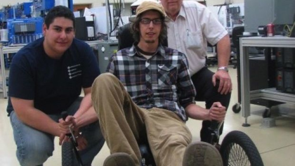 Western Iowa Tech Community College students Juan Verdin and Nathan Schulz are joined by mechanical engineering technology instructor Tom Helzer, right, on the recumbent trike that won the best technology award in a competition held at the University of I