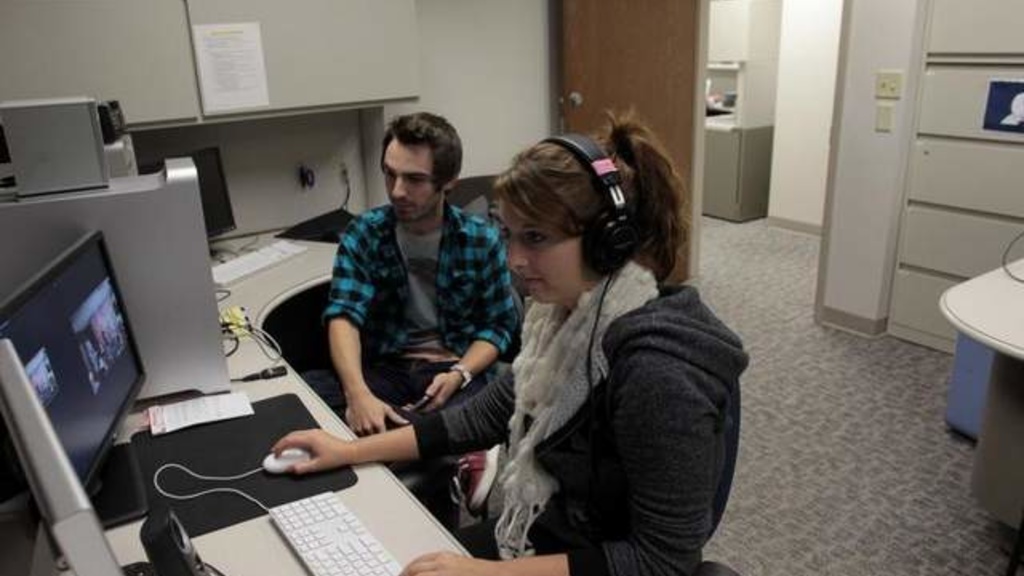 Meghan Horihan and Zach Phelps edit video Monday. The University of Iowa is partnering with Mediacom to broadcast content statewide from campus through the Hawkeye Network. / David Scrivner / Iowa City Press-Citizen
