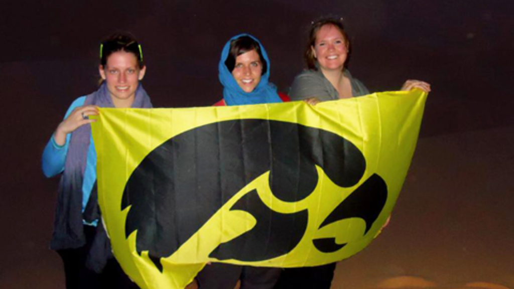 Melanie Martin (right) holds an Iowa flag in Morocco as part of a study abroad experience