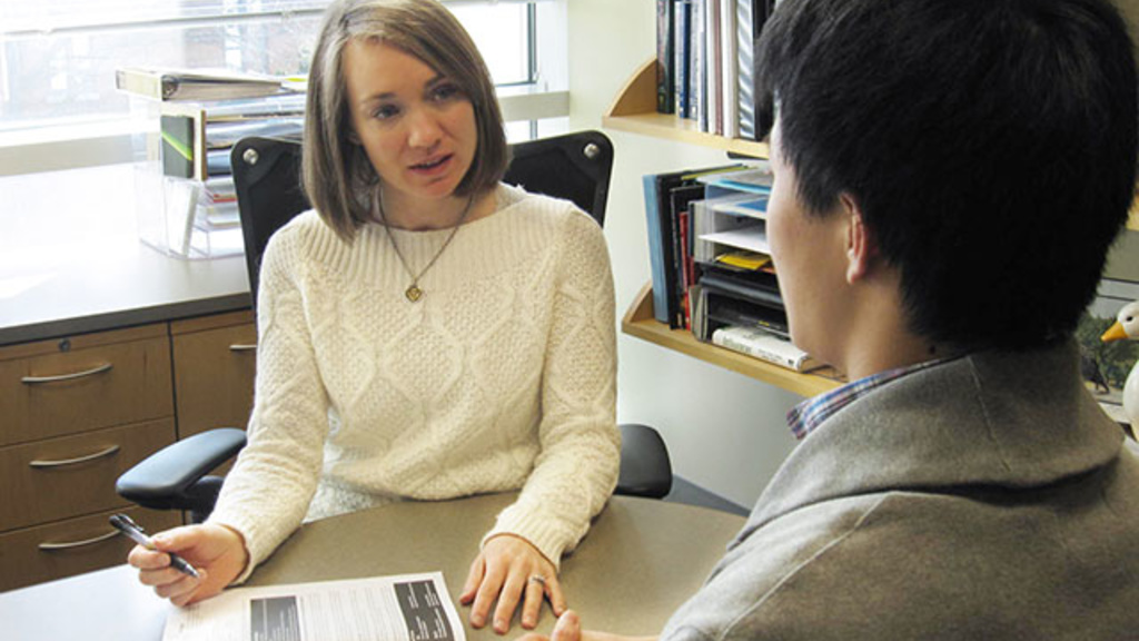 Amy A'Hearn talking with a student in her office