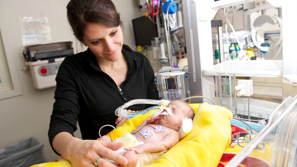 mother with preemie baby in NICU