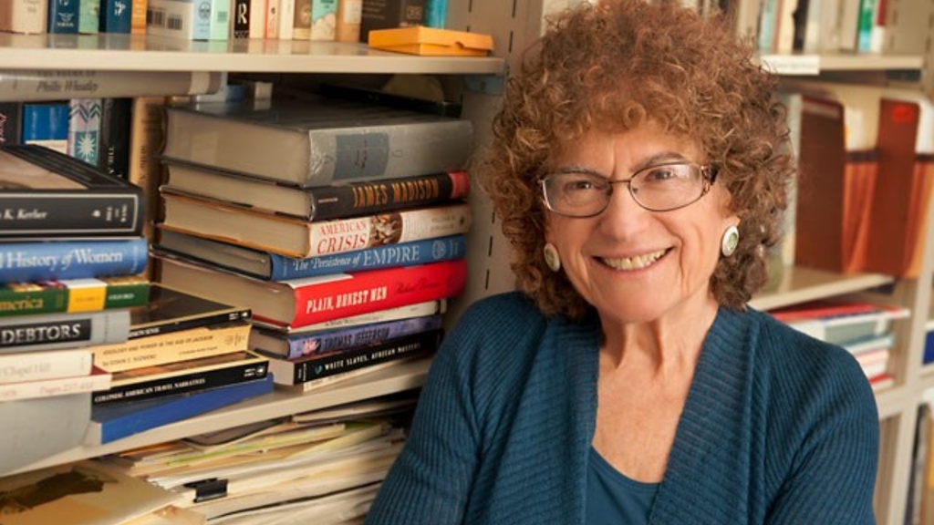 Photo of UI emeritus history professory Linda Kerber in her office in front of a bookshelf