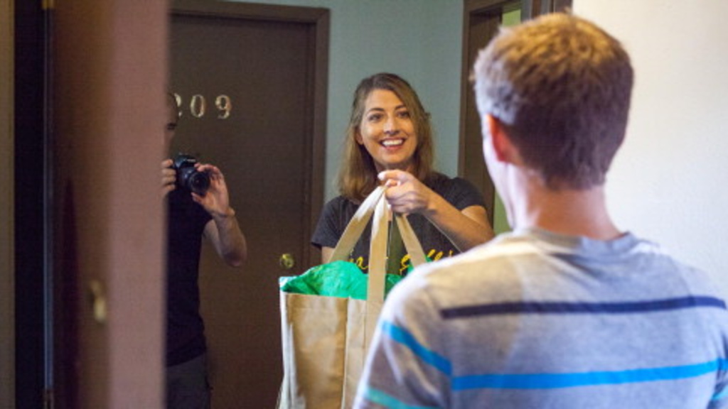 Leslie O&#039;Hare of Your Campus Mom acts out her grocery delivery service with actor Kyle Walther, a University of Iowa graduate student, during the filming of a commercial for her business last week in Iowa City