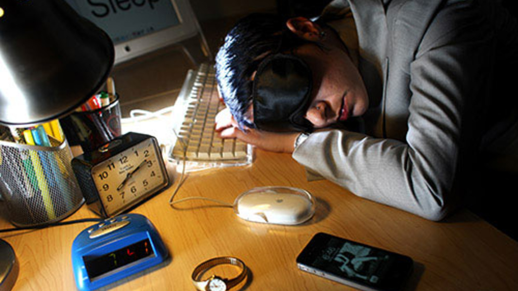 Daily Iowan photo of a student asleep in front of their computer keyboard with head resting on desk.