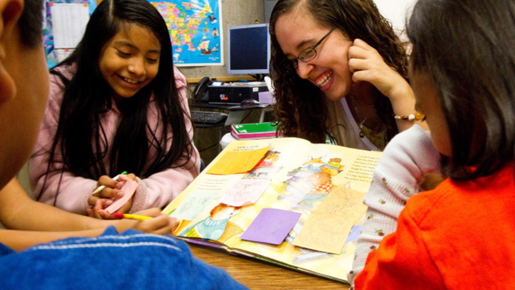 University of Iowa junior Rachel Revelez (right) reads to her students, including Lariza Martinez (left) Van Buren Elementary School in Cedar Rapidsm, where she is doing her practicum.. (Kyle Grillot/The Gazette