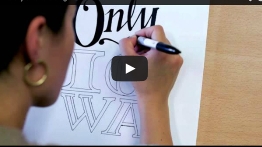 A person draws Only At Iowa as part of UI College of Education&#039;s Annual Report