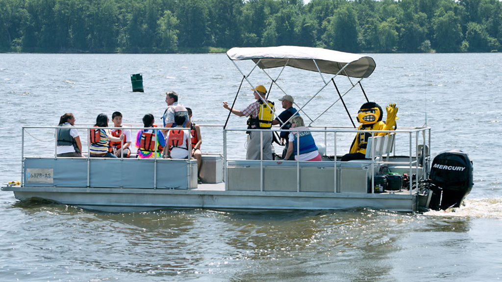 students, researchers, and Herky on pontoon