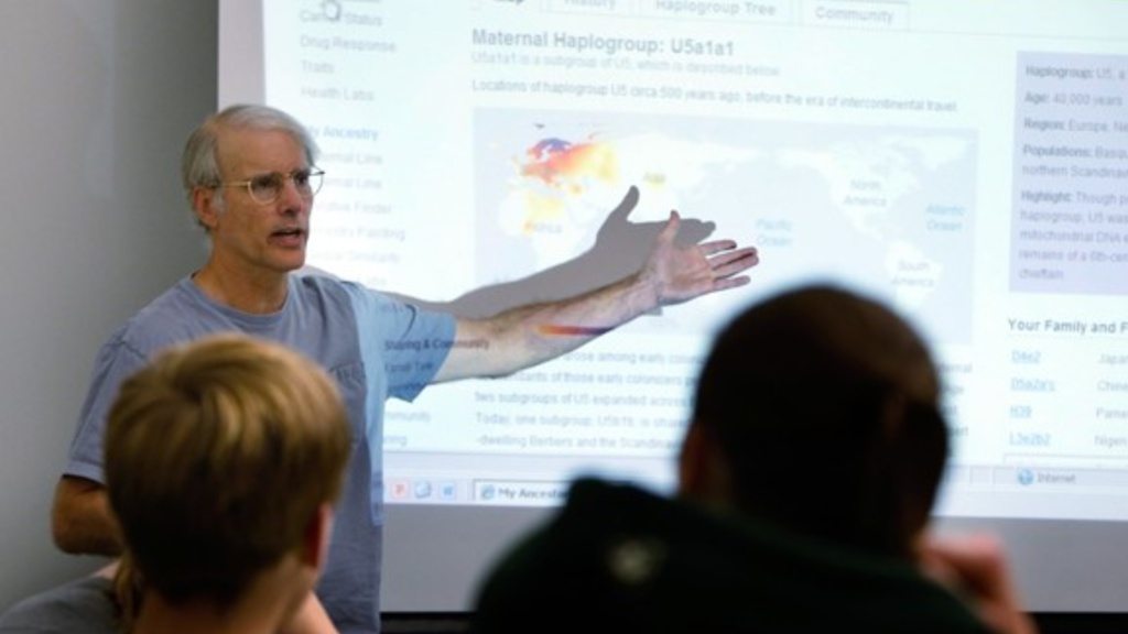 University of Iowa professor Jeff Murray gestures to a PowerPoint presentation while he talks about his genetic profile during an honors seminar on personal genetics. 
