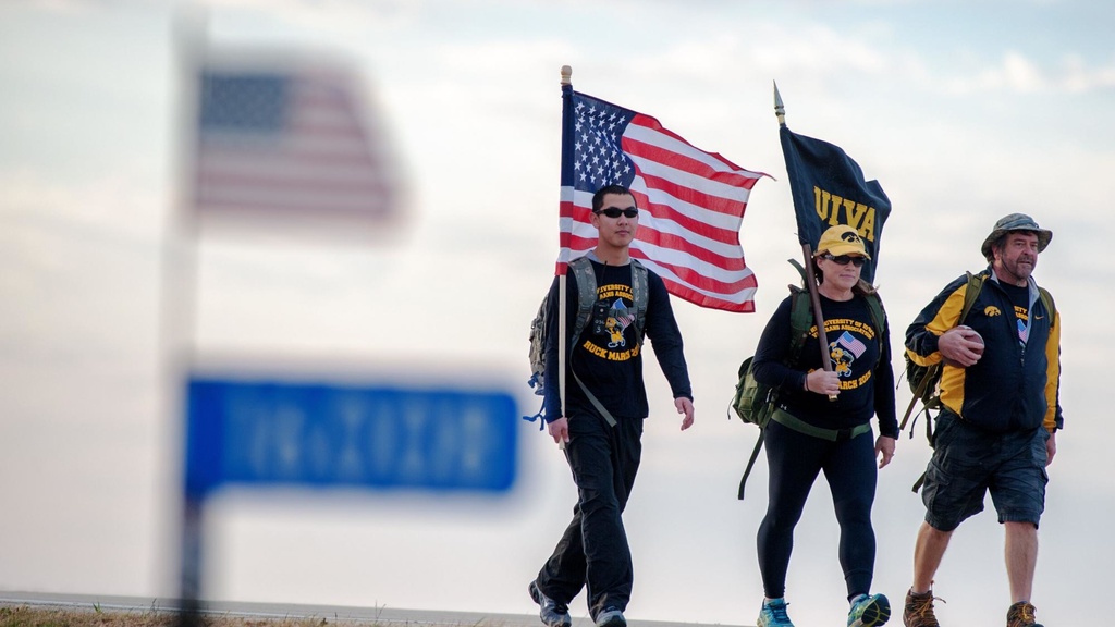 University of Iowa graduate and veteran Randy Miller (right), rucks alongside USAF veteran Patty Considine, and Iowa National Guardsman Jimmy Luu on Tuesday, Nov. 10 as part of the UIVA's Game Ball Ruck for veteran suicide awareness.