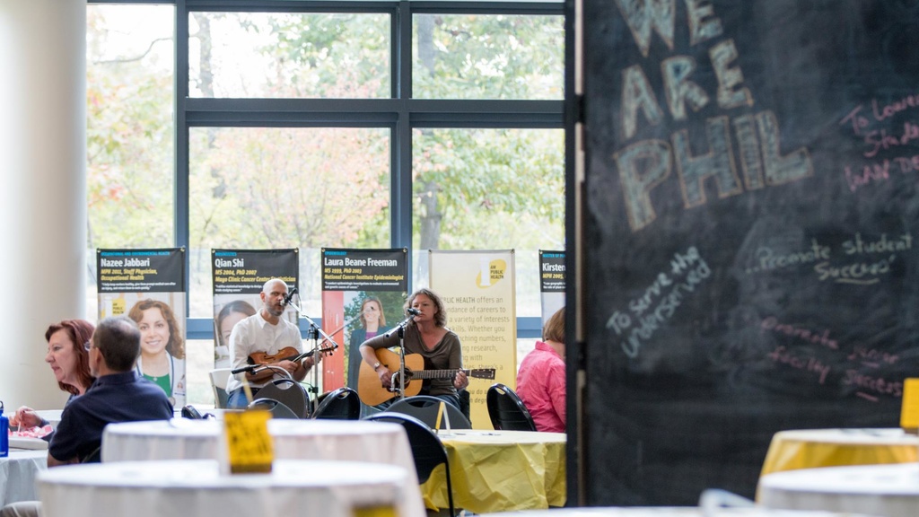 Marc and Brandi Janssen, well-loved Iowa roots musicians, entertained faculty and staff during a We Are Phil lunchtime gathering in the College of Public Health. Brandi is a faculty member in the college and director of Iowa’s Center for Agricultural S