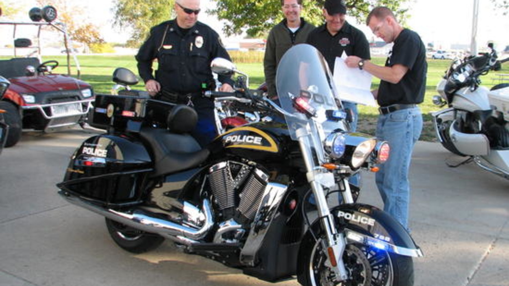 Photo by Russ Mitchell/ Members of the University of Iowa&#039;s Police Division pick up a pair of Victory Motorcycles customized for law enforcement at a Spirit Lake factory. 
