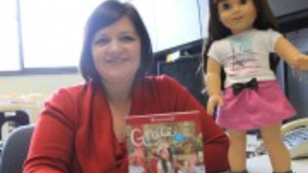 Dawn Bowlus with an American Girl Doll and educational curriculum that she helped develop.